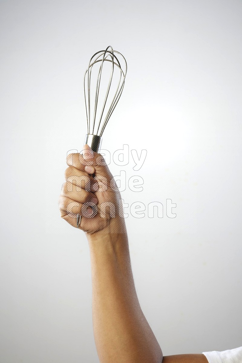 Male Hand Holding Whisk on white background