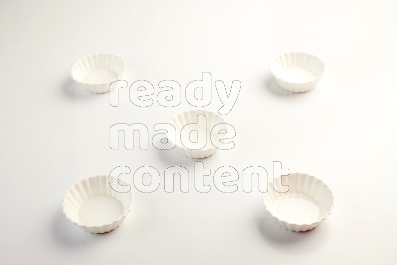 white ceramic round sauce dish on white countertop