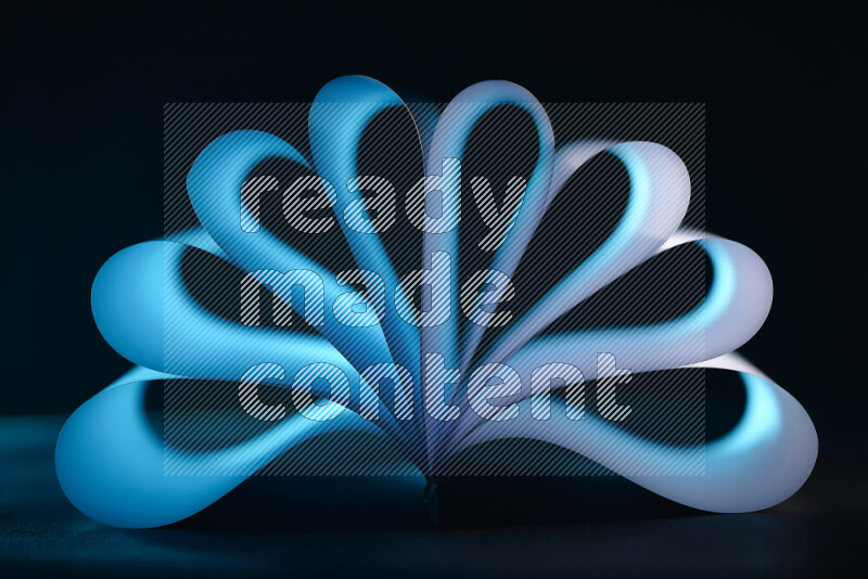 An abstract art piece displaying smooth curves in blue gradients created by colored light