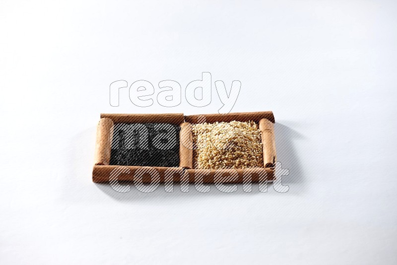 2 squares of cinnamon sticks full of sesame and black seeds on white flooring