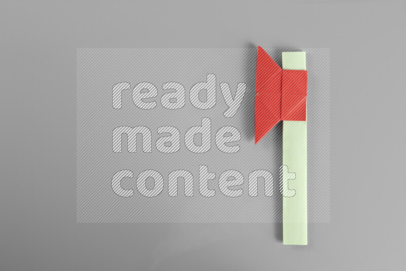 Origami axe on grey background