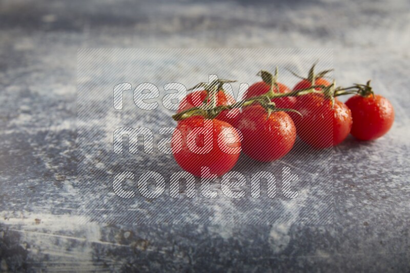 Red cherry tomato vein on a textured rusty blue background 45 degree