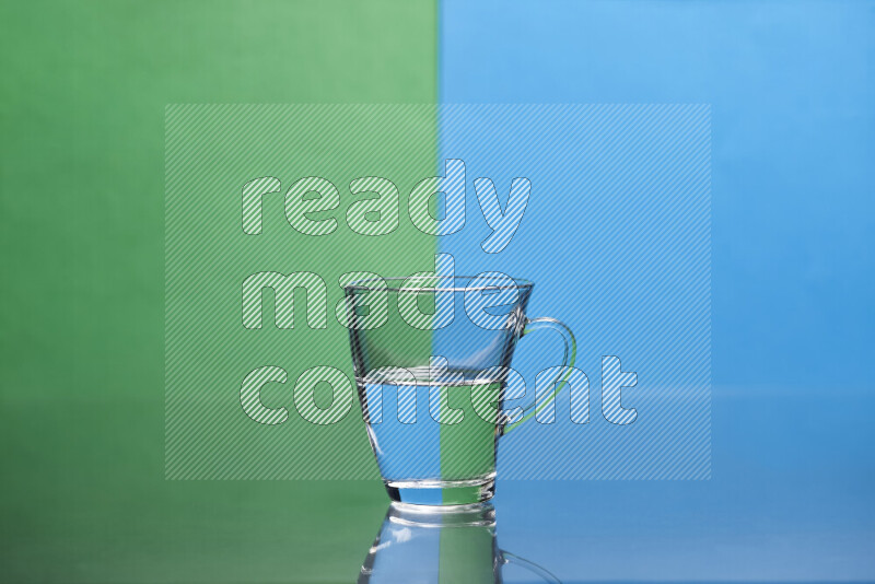 The image features a clear glassware filled with water, set against green and blue background