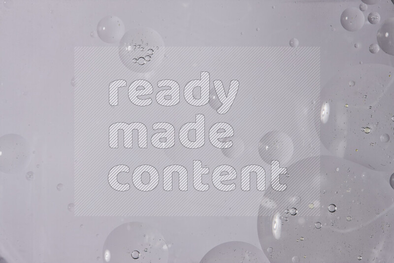 Abstract oil droplets in a water surface on white background