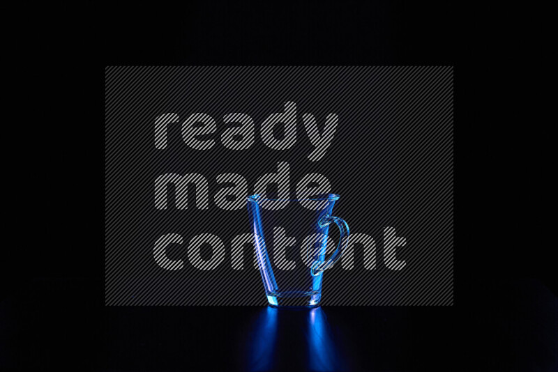 Glassware with rim light in blue against black background