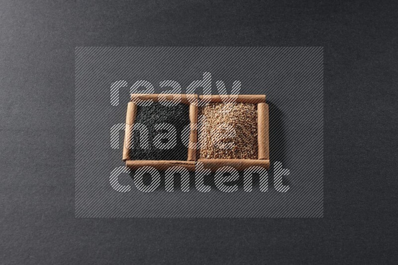 2 squares of cinnamon sticks full of mustard seeds and black seeds on black flooring