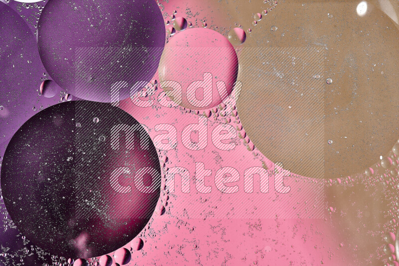 Close-ups of abstract oil bubbles on water surface in shades of brown, purple and pink