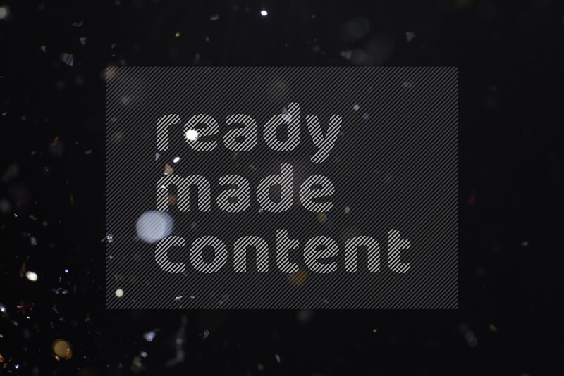 Falling multicolored confetti on black background