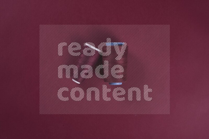 A red collection of sewing and tailoring tools arranged on a red background