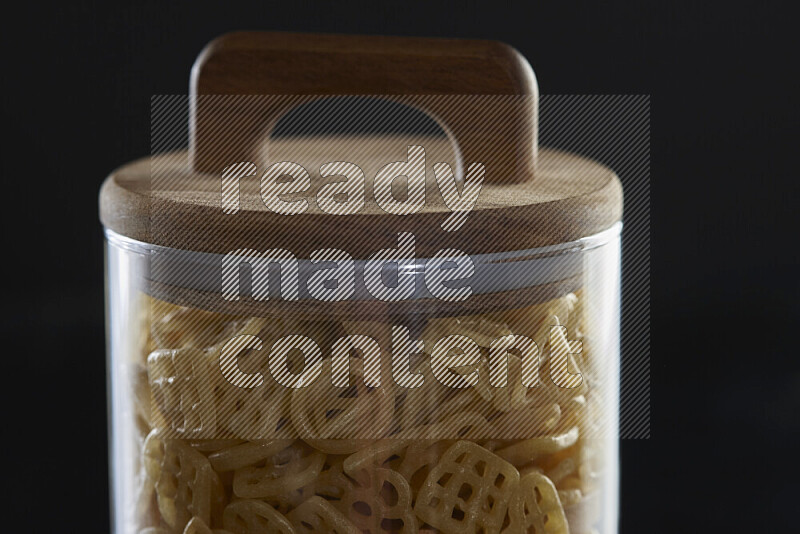 Snacks in a glass jar on black background