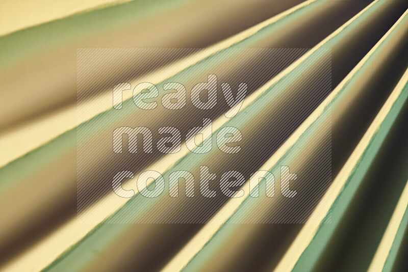 An image presenting an abstract paper pattern of lines in green and gold tones