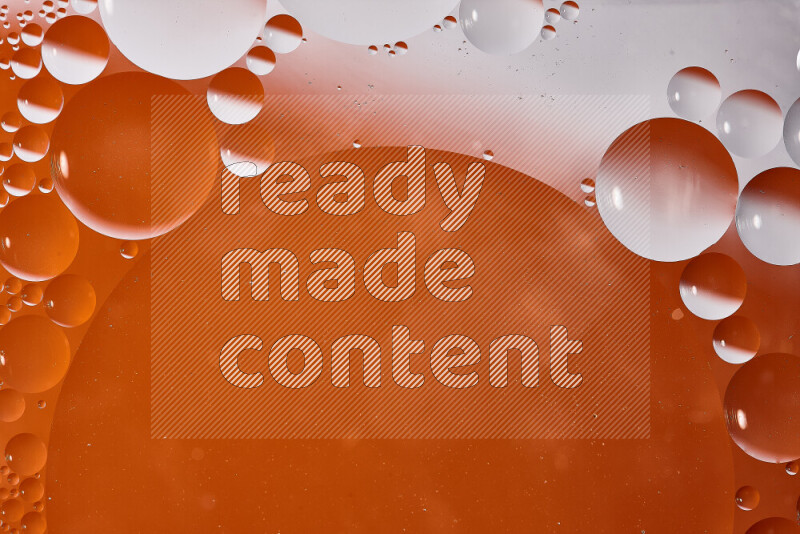 Close-ups of abstract oil bubbles on water surface in shades of white and orange