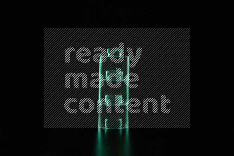 Glassware with rim light in green against black background