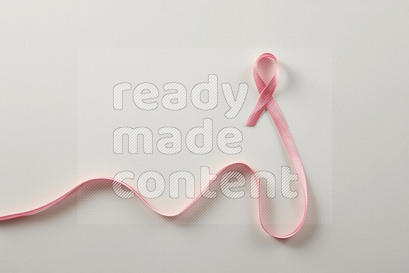 Pink ribbons on white background