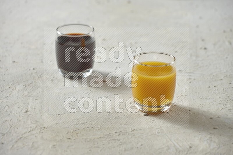 Cold drinks in a glass cup such as water, tamarind, qamar eldin, sobia, milk and hibiscus on textured white background