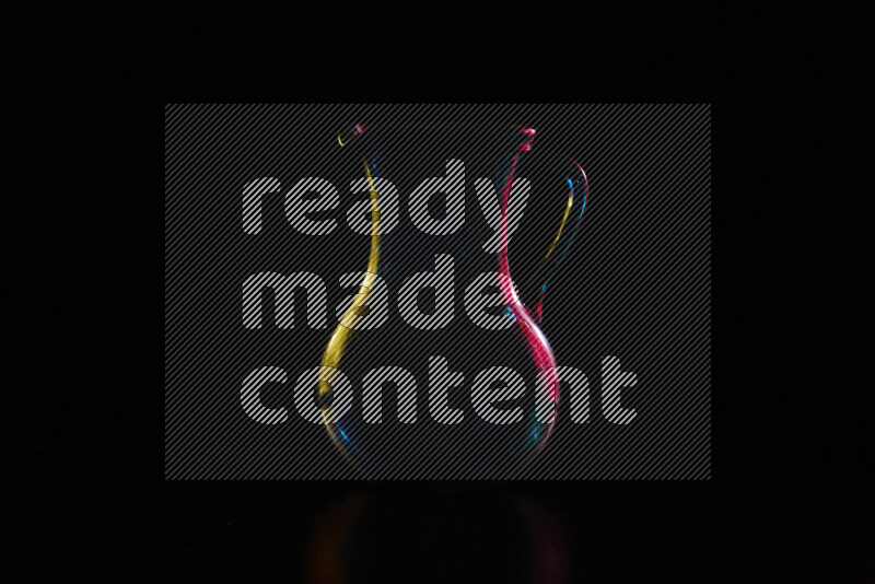 Glassware with rim light in red and yellow against black background