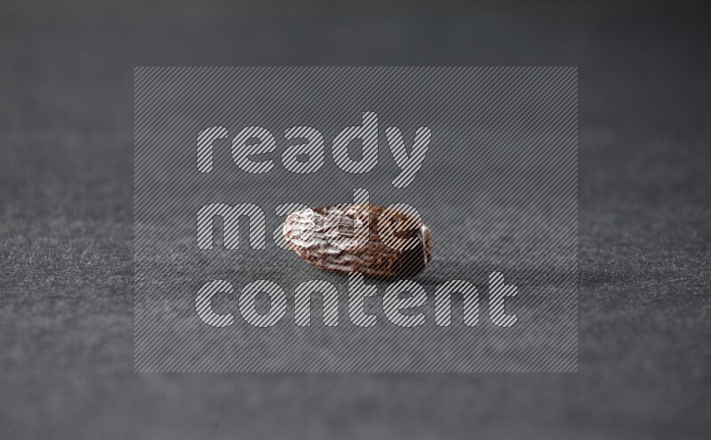 Dried dates on a black background in different angles