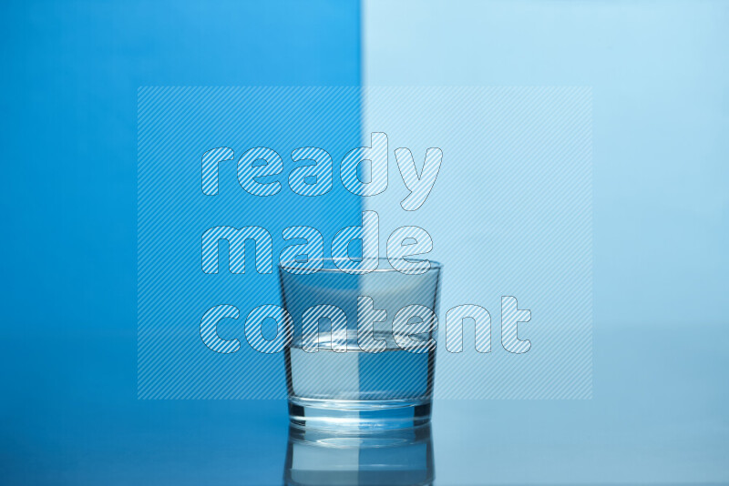 The image features a clear glassware filled with water, set against blue and light blue background