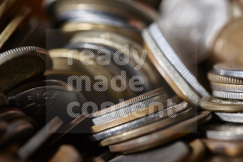 A close-ups of random old coins on black background