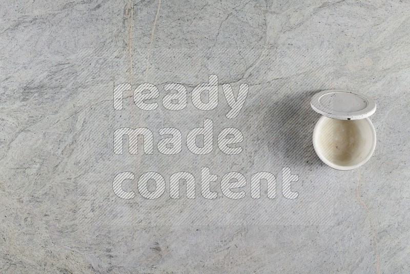 Top View Shot Of A Multicolored Pottery Cup On Grey Marble Flooring