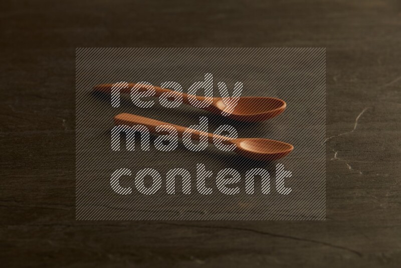 wooden spoon on black slate background