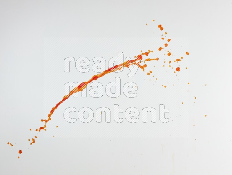 Orange liquid splash and drops on white background