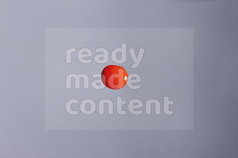 Close-ups of abstract red paint droplets on grey background