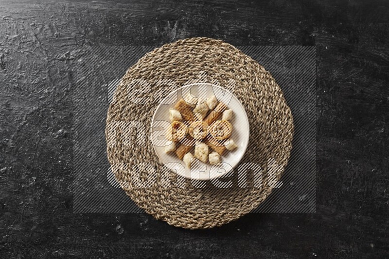 Oriental sweets in pottery plates in a dark setup