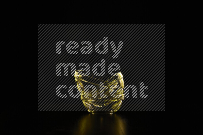 Glassware with rim light in yellow against black background