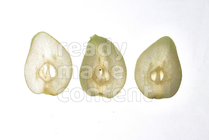 Pear slices on illuminated white background