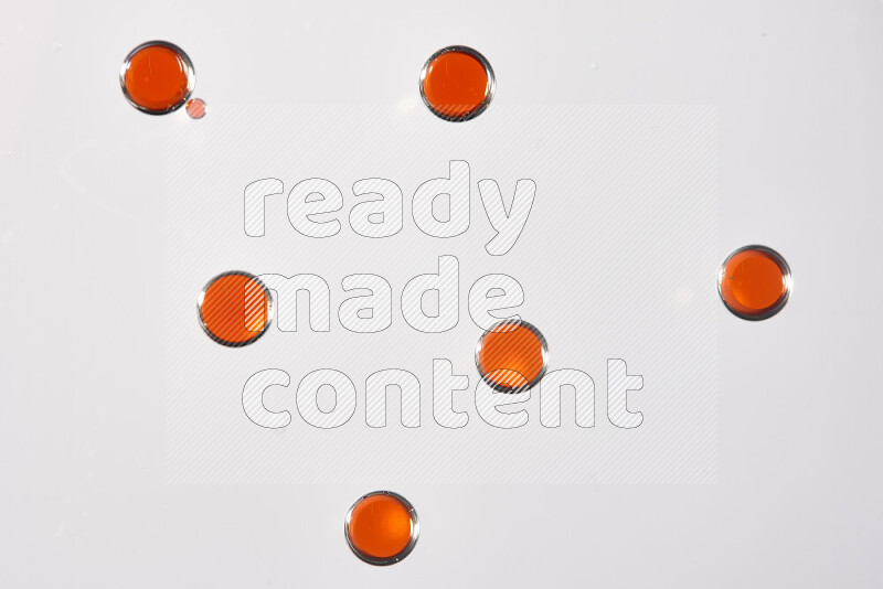 Close-ups of abstract red watercolor drops on oil Surface on white background