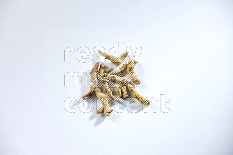 Dried turmeric whole fingers on white flooring