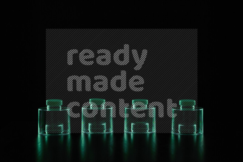 Glassware with rim light in green against black background