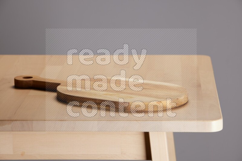 wooden trays and cutting boards on the edge of wooden table
