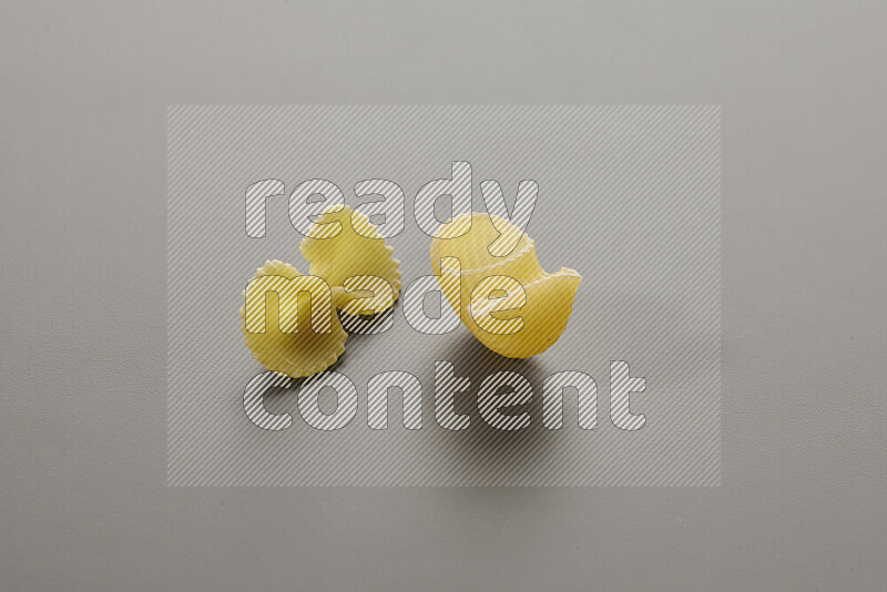 Fiocchi pasta with other types of pasta on grey background