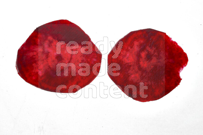 Beet slices on illuminated white background