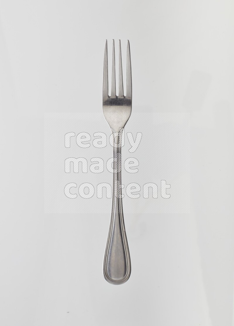 Silver stainless steel fork on white background
