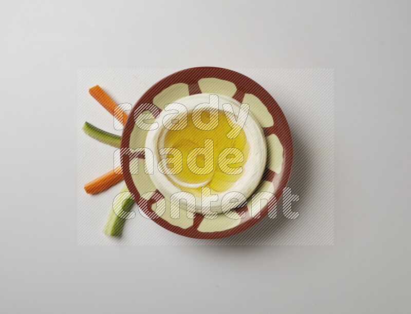 Lebnah garnished with olive oil in a traditional plate on a white background