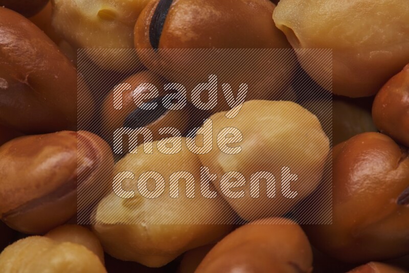 Close up shot of cooked fava beans (foul) & chickpeas on white background