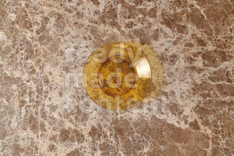 Top View Shot Of A Circular Glass Plate On beige Marble Flooring