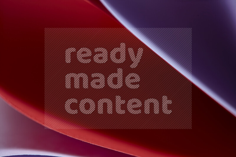 An abstract art showing purple and red paper sheets arranged in an overlapping curves