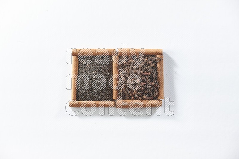 2 squares of cinnamon sticks full of black tea and cloves on white flooring