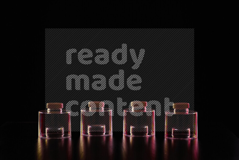 Glassware with rim light in red and yellow against black background