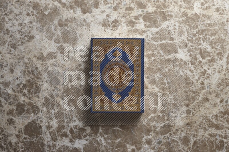 The holy Quran on beige marble background