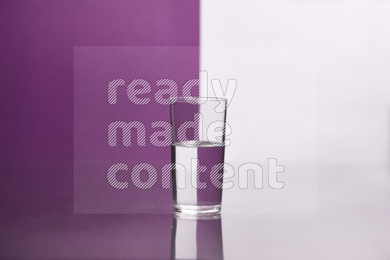 The image features a clear glassware filled with water, set against white and purple background