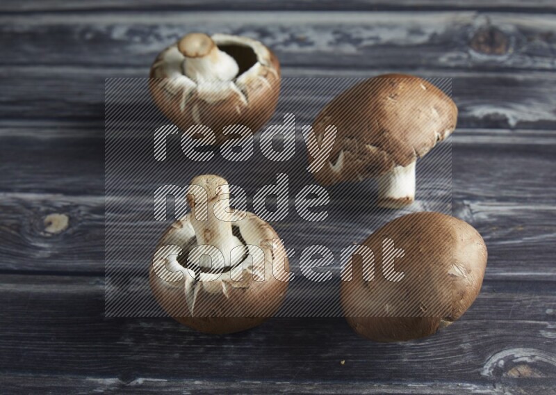 45 degree Cremini  mushrooms on a textured grey background