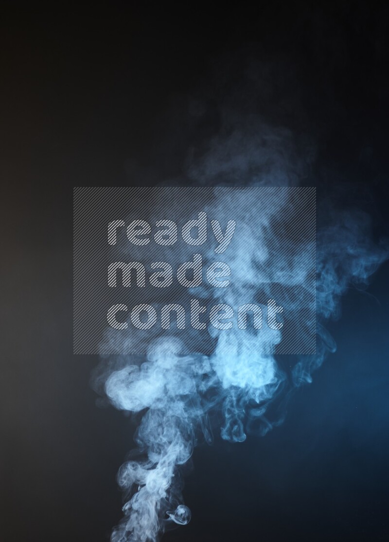 Heavy smoke in blue and yellow isolated on black background