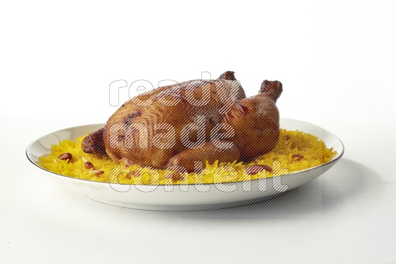 yellow  basmati Rice with kabsa chicken pieces on a white plate with a silver rim direct on white background