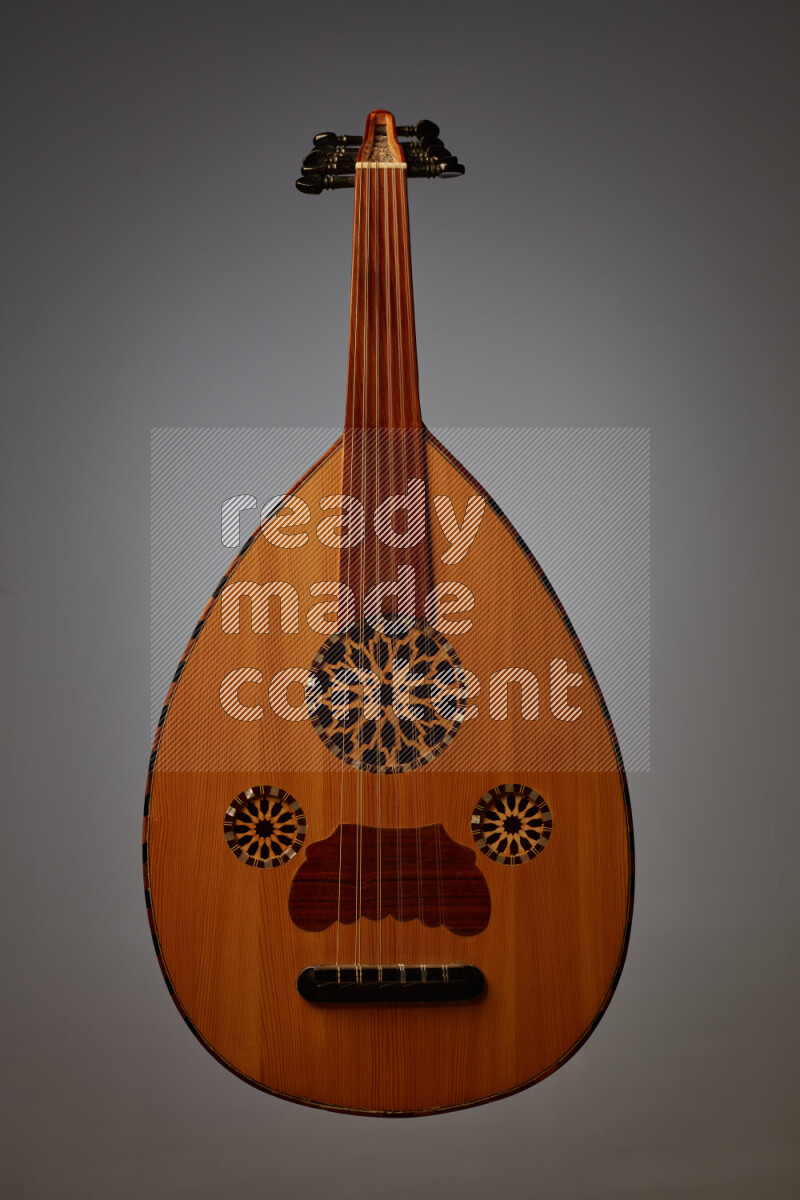 a wooden brown Oud on a gray background