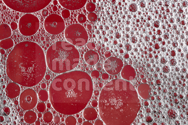 Close-ups of abstract soap bubbles and water droplets on red background